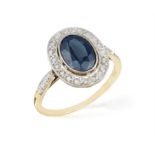 AN EARLY 20TH CENTURY SAPPHIRE AND DIAMOND DRESS RING, the central oval-shaped sapphire within