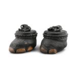 A PAIR OF 19TH CENTURY EBONY MOUNTED ELEPHANT FOOT CASKETS, India, with sandlewood lining, the