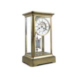 AN EDWARDIAN BRASS CASED TALL MANTLE CLOCK, with white enamel dial, striking movement and with