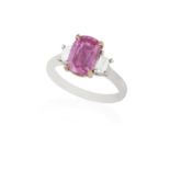 A COLOURED SAPPHIRE AND DIAMOND DRESS RING The elongated cushion-shaped pink sapphire weighing 2.