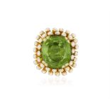 A PERIDOT AND DIAMOND COCKTAIL RING, BY MARCHAK, CIRCA 1965 The cushion-shaped peridot weighing