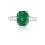 A RARE AND FINE EMERALD AND DIAMOND RING, BY CARTIER The octagonal step-cut emerald weighing 3.