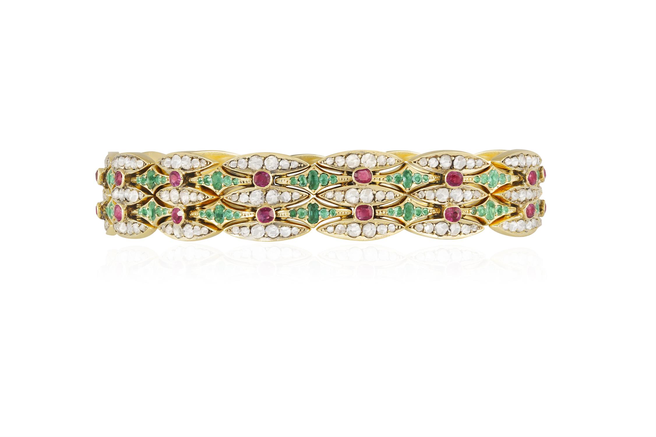 A LATE 19TH/EARLY 20TH CENTURY EMERALD, RUBY AND DIAMOND BRACELET Of openwork articulated design,