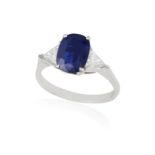 A SAPPHIRE AND DIAMOND DRESS RING The oval-shaped sapphire weighing approximately 1.