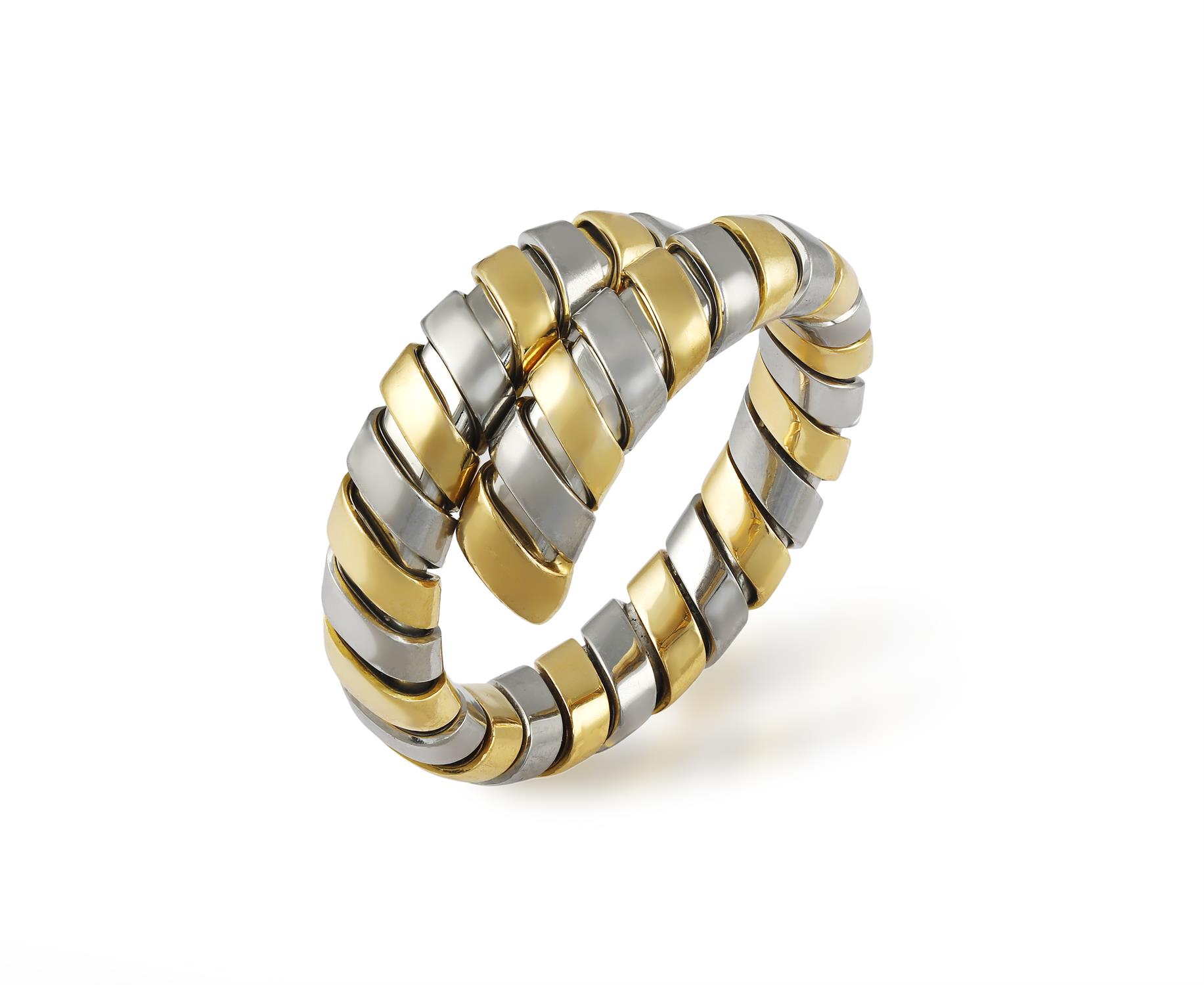 A GOLD AND STEEL TUBOGAS RING, BY BULGARI Of flexible bi-coloured coil design,