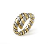A GOLD AND STEEL TUBOGAS RING, BY BULGARI Of flexible bi-coloured coil design,