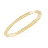 A GOLD BANGLE, BY TIFFANY & CO. The polished gold twisted bangle, mounted in 18K gold,