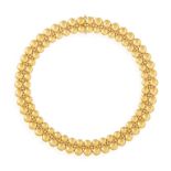 A GOLD 'PASTILLE' NECKLACE, BY CARTIER The flexible two-tone reversible band composed of