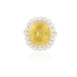 A COLOURED SAPPHIRE AND DIAMOND CLUSTER RING The cushion-shaped yellow sapphire weighing