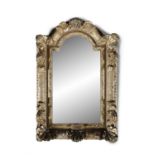 A SMALL 19TH CENTURY CONTINENTAL ARCHED RECTANGULAR CARVED GILTWOOD MIRROR with bevelled mirror