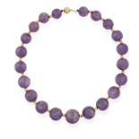 AN AMETHYST BEAD NECKLACE, composed of graduated carved amethyst beads, each interspersed with