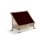 A 19TH CENTURY GILT BRASS READING STAND with velvet lined slope front panel, the border and side