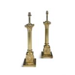 A PAIR OF CAST BRASS CORINTHIAN COLUMN TABLE LAMPS, the reeded columns on square bases with lion