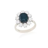 A SAPPHIRE AND DIAMOND CLUSTER RING, the oval-shaped sapphire weight approximately 2.50cts,