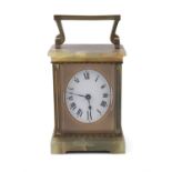 A FRENCH ONYX AND GILTMETAL TRAVELLING CARRIAGE CLOCK, of rectangular form with swing handle,