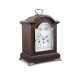 A STAINED WOOD CASED MANTLE CLOCK, in the Georgian taste, with silvered dial and chiming movement,