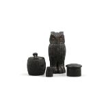 AN IRISH BOG OAK OWL IN THE MANNER OF GOGGIN, 11.5cm high; together with a small tub shaped ink pot