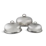 A SET OF THREE SILVER PLATED DISH COVERS, of graduated sizes, of plain design, gadrooned rim and