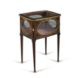 A LOUIS QUINZE STYLE ORMOLU MOUNTED CURIO TABLE, the hinged tip with bevelled glass above oval