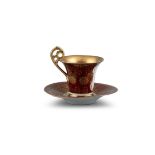 A CONTINENTAL ROUGE AND GILT GROUND PORTRAIT CUP AND SAUCER, Vienna c.1900, painted with a