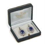 A PAIR OF EARLY 20TH CENTURY SAPPHIRE AND DIAMOND CLUSTER EARRINGS, each set centrally with an