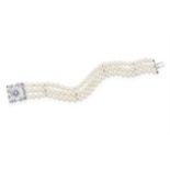 A CULTURED PEARL BRACELET WITH SAPPHIRE AND DIAMOND CLASP, CIRCA 1960, composed of three rows of