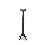 A MAHOGANY PILLAR TORCHERE, the circular top with gallery rail on a spiral turned column and