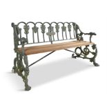 A VICTORIAN GREEN PAINTED CAST IRON GARDEN BENCH, probably Coalbrookdale, the arched back cast with