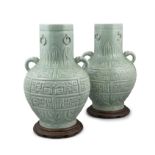A PAIR OF PALACE-SIZE CELADON-GLAZED TWO-HANDLED PORCELAIN VASES APOCRYPHAL MARK OF EMPEROR