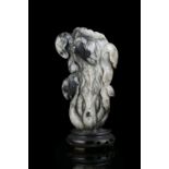 A MOTTLED JADE CARVING OF A CHINESE CABBAGE CHINA, QING DYNASTY Naturalistically carved in a mottled