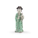 PROPERTIES FROM THE P. COLLECTION OF BISCUIT PORCELAIN WARES A GREEN ENAMELED BISCUIT FIGURE OF