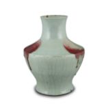 A PURPLE SPLASHED CRACKLE CELADON PORCELAIN VASE OF ARCHAISTIC HU SHAPE CHINA, QING DYNASTY It rests