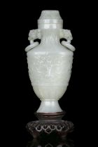 A JADE VASE AND COVER OF ARCHAISTIC FANGHU SHAPE CHINA, LATE QING DYNASTY it rests on a tall and