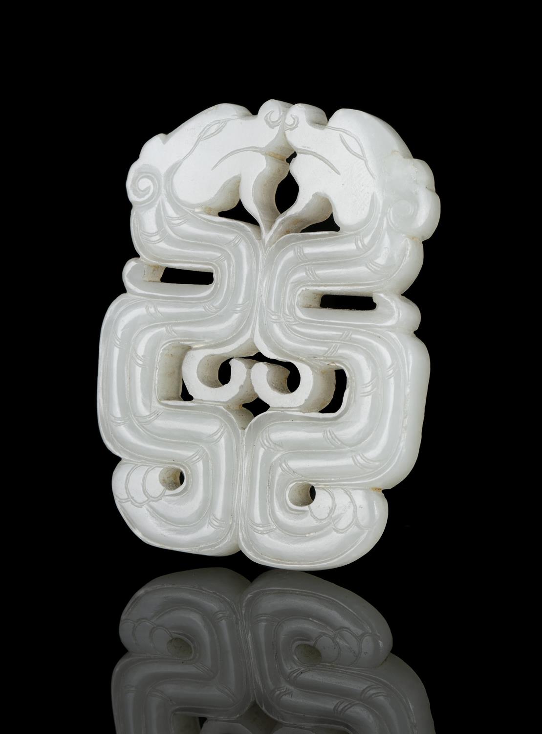 A RETICULATED JADE ‘KUI DRAGONS’ PLAQUE / PENDANT CHINA, LATE QING DYNASTY Finely carved and