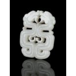 A RETICULATED JADE ‘KUI DRAGONS’ PLAQUE / PENDANT CHINA, LATE QING DYNASTY Finely carved and