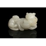 A WHITE JADE GROUP OF TWO CATS WITH A BUTTERFLY 玉耄耋 CHINA, POSSIBLY QING DYNASTY Carved out of an