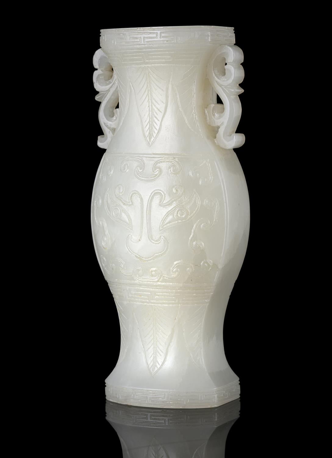 A WHITE JADE ‘TAOTIE MASK’ JOYSTICK HOLDER OF ARCHAISTIC GU SHAPE CHINA, QING DYNASTY Of