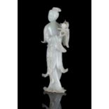 A FINE JADEITE JADE CARVING OF A STANDING MEIREN CHINA, CIRCA 1900-1930 The stone of white tone with