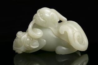 A JADE CARVING OF A PIXIE / BIXIE CHINA, QING DYNASTY Offered at auction with a wooden stand