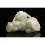 A JADE CARVING OF A PIXIE / BIXIE CHINA, QING DYNASTY Offered at auction with a wooden stand