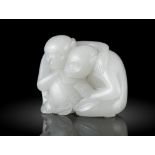 A WHITE JADE CARVING OF TWO MONKEYS WITH A PEACH CHINA, POSSIBLY QING DYNASTY OR LATER Carved out of