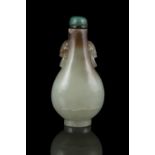A PEAR-SHAPED JADE SNUFF BOTTLE CHINA, QING DYNASTY Carved out of a celadon stone with brown