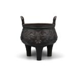 A HEAVY AND CRISPY CAST ‘TAOTIE MASK’ METAL VESSEL OF ARCHAISTIC DING 鼎 SHAPE CHINA, POSSIBLY LATE