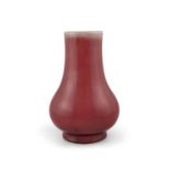 *A FLAMBE / OXBLOOD GLAZED PORCELAIN BALUSTER VASE CHINA, MODERN It rests on a spread foot and has a