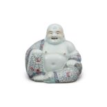 A FAMILLE ROSE PORCELAIN SCULPTURE OF A BUDAI OR MILEFO CHINA, 20TH CENTURY The budai seated in
