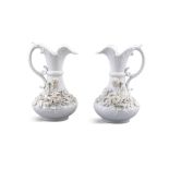 A PAIR OF IRISH BELLEEK SECOND PERIOD ABERDEEN JUGS, the wavy rims and applied scroll handles on a
