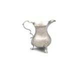 A SILVER HELMET SHAPED CREAMER, with wavy rim, and applied acanthus wrapped c-scroll handle,