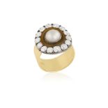 A DIAMOND AND PEARL DRESS RING Composed of a circular pearl within collet-setting and surround