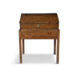 AN 18TH CENTURY STAINED OAK SLOPE TOP WRITING DESK, with three internal drawers, on a table base