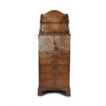 A GEORGE III MAHOGANY UPRIGHT CABINET, with open book compartment above a twin door cupboard,